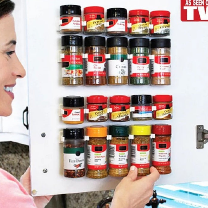 White adhesive spice rack attached to cabinet door with spice bottles