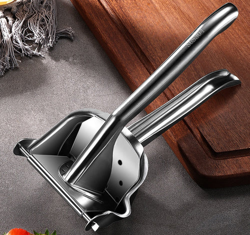 Stainless steel citrus juicer being pressed to extract juice