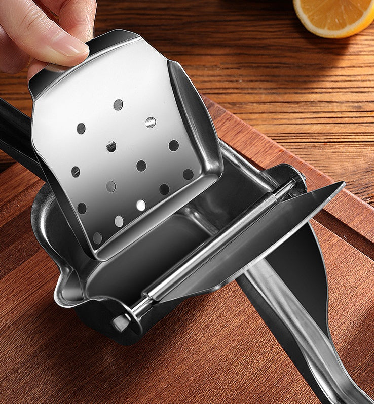 Stainless steel citrus juicer with cut lemon in the bowl