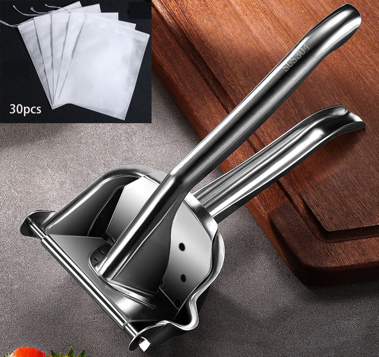 Close-up of stainless steel citrus juicer with juice dripping from spout