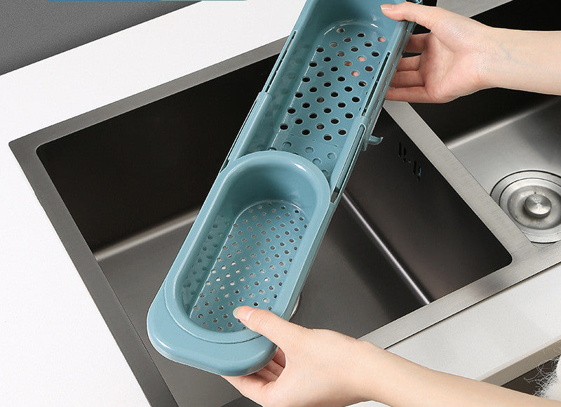 Close-up of sink rack with blue sponge and brush