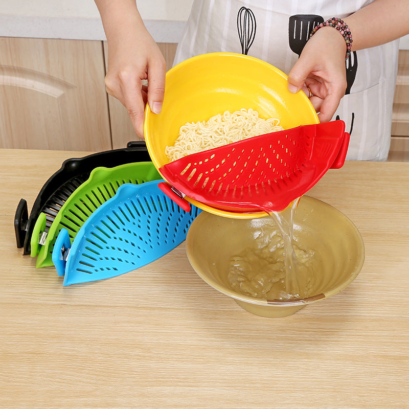 Clip-on silicone pot strainer attached to cookware for draining pasta and vegetables