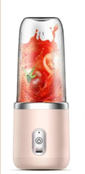Pink portable blender with white lid and dark blue lid beside it